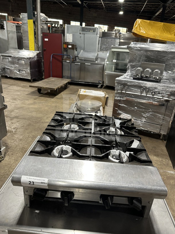 American Range stainless steel 4-burner gas hot plate, thermostatic controls, excellent condition, auction tag 23 visible.