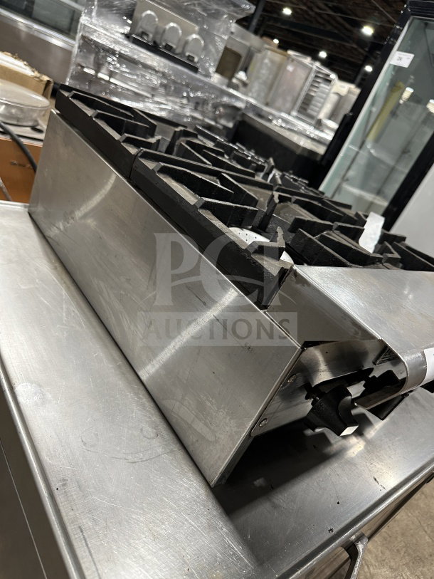 American Range stainless steel 4-burner hot plate with thermostatic controls, gas-powered, in good condition.