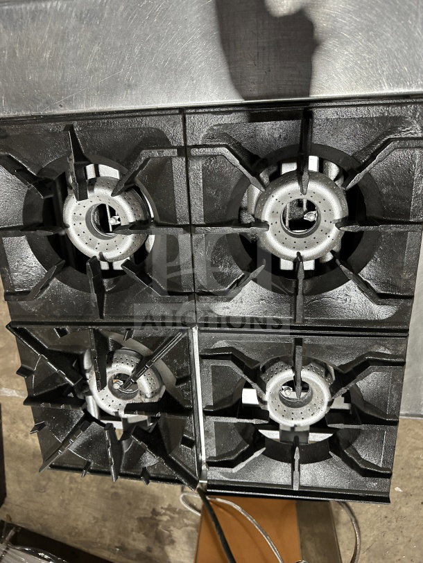 American Range stainless steel 4-burner hot plate with thermostatic controls; gas powered, commercial grade, excellent condition.