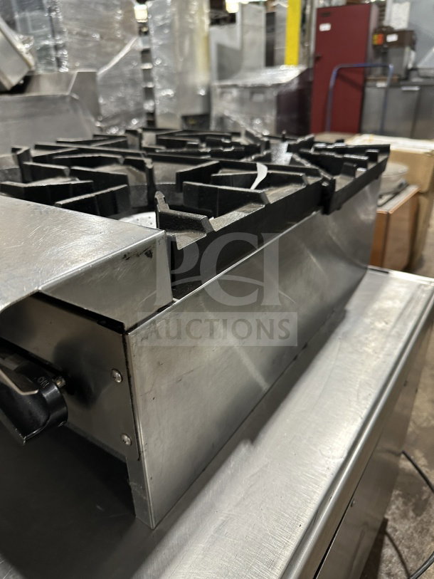 American Range commercial stainless steel 4-burner hot plate, gas powered, with thermostatic controls. Durable, excellent condition.