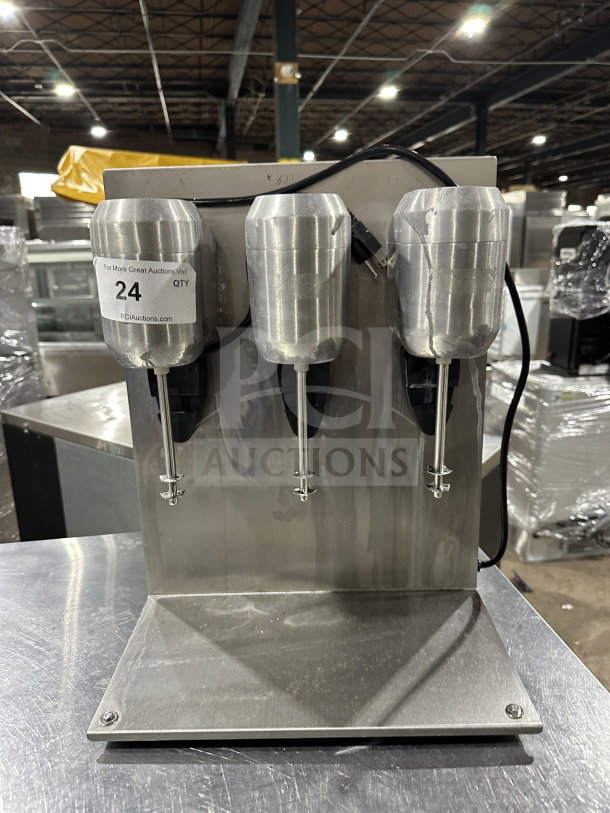 Commercial stainless steel triple-spindle drink mixer, excellent condition, numbered tag "24," sturdy construction.