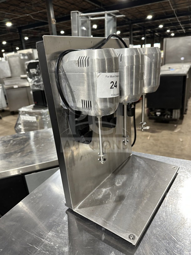 Commercial stainless steel triple-spindle drink mixer, excellent condition, sleek design, auction tag number 24 visible.