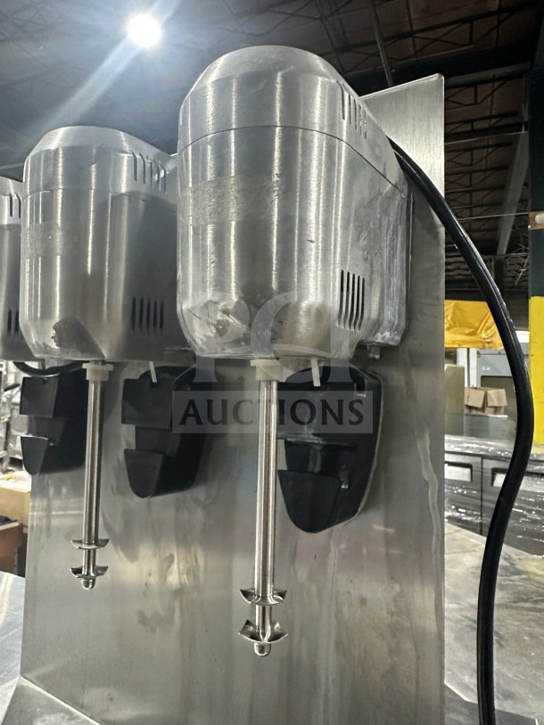 Commercial stainless steel triple-spindle drink mixer; sturdy construction, used condition, ideal for food service.