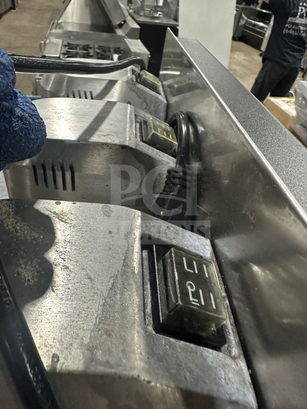Great! Commercial stainless steel triple-spindle drink mixer, showing metal surface and control switches. Good condition.