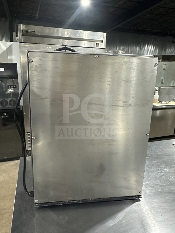 Commercial stainless steel triple-spindle drink mixer, industrial design, excellent condition, visible power cord.