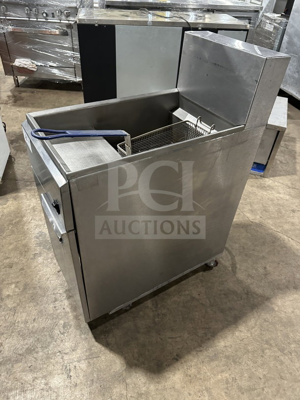 Imperial commercial stainless steel electric fryer with back splash, basket hanger, and fry basket; on casters.
