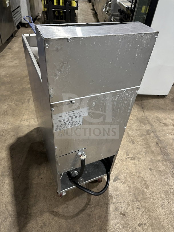 Imperial Commercial Stainless Steel Electric Deep Fat Fryer with backsplash, basket hanger, and fry basket on casters.
