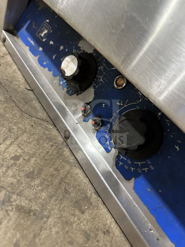 Bakers Pride P18 stainless steel pizza oven controls, showing wear on blue panel. Model: P18. 208/240V, 1 Phase.