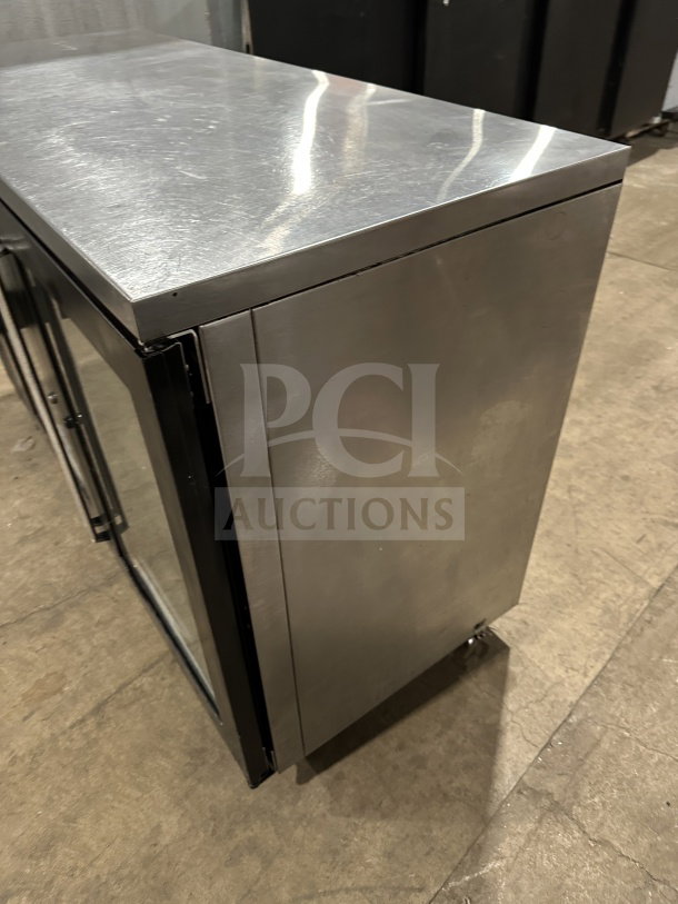 Perlick BBS60RM commercial stainless steel glass 2-door bar back cooler with chrome plated wire rack on casters.