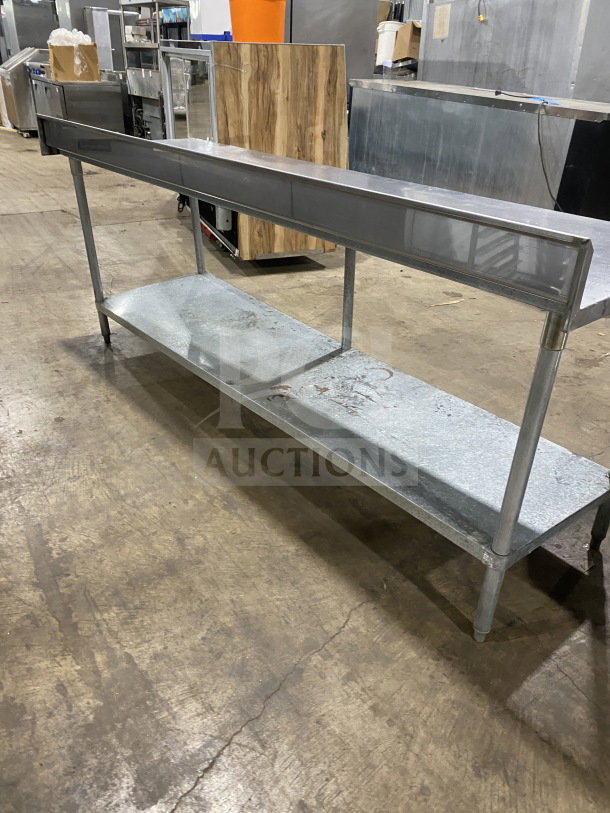 L&J stainless steel undershelf worktop table in good condition, on sturdy legs, ideal for commercial use.