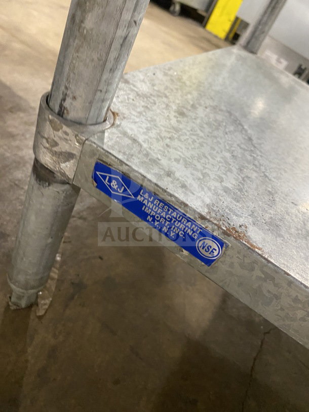 L&J stainless steel worktop table, single undershelf, on legs, shows blue label with NSF certification.