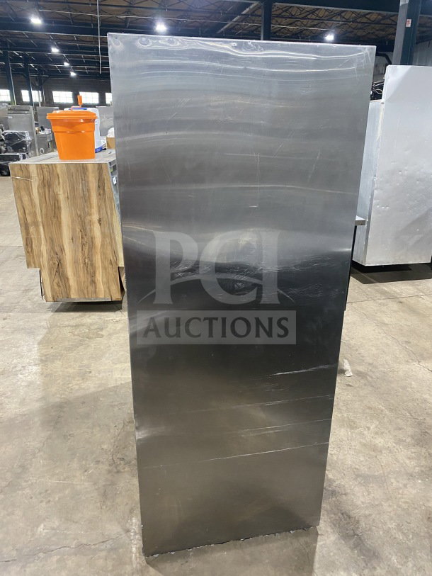 Leader commercial stainless steel refrigerator, model LS54SC. Features rear access sliding glass doors, poly-coated racks; good condition.