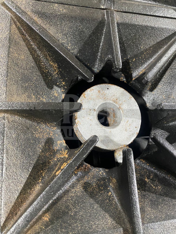Close-up of burner grate on Southbend S241E range, showing moderate rust and wear.