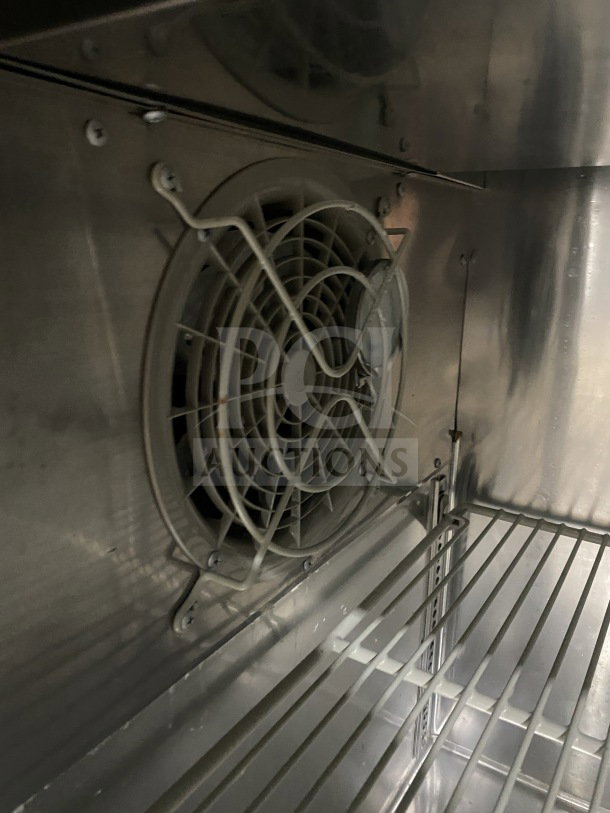 Turbo Air J-Series JUR-36 undercounter refrigerator interior with side mounted compressor and poly-coated wire rack.