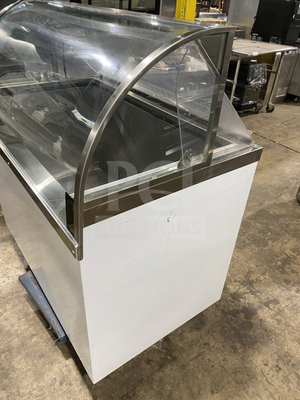 Commercial white curved glass 46" ice cream/frozen yogurt dipping cabinet with rear lift-open access, in good condition.