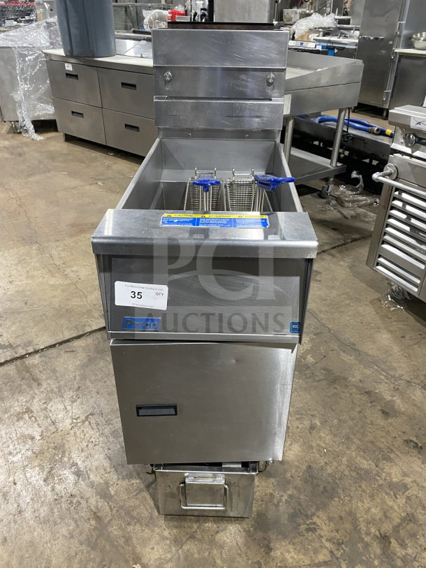 Pitco SFSG14JS stainless steel 40 lb. deep fryer with filtration, backsplash, basket hanger, and fry basket on casters.