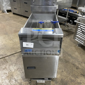 Pitco SFSG14JS stainless steel 40 lb. deep fryer with filtration, backsplash, basket hanger, and fry basket on casters.