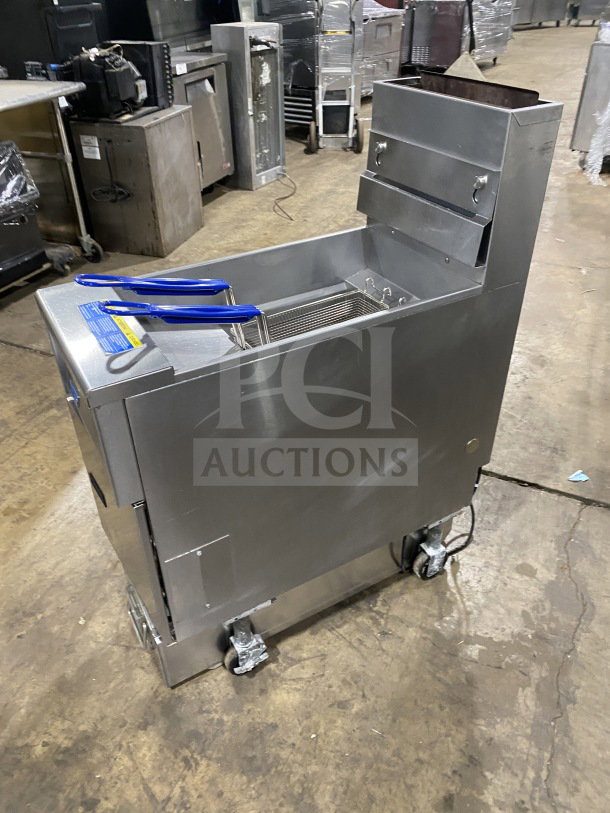 Pitco SFSG14JS 40 lb. stainless steel natural gas fryer with filtration, backsplash, basket hanger, and casters.