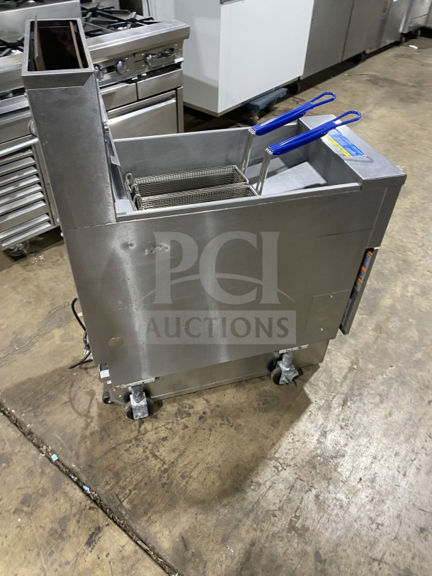 Pitco SFSG14JS stainless steel 40 lb. deep fat fryer with backsplash, basket hanger, filtration system, and casters.