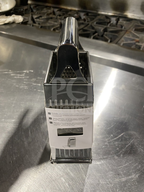 Brand new Westmark Quattro Series 4-sided stainless steel box grater, model 11382270, with sliding closure and tag.