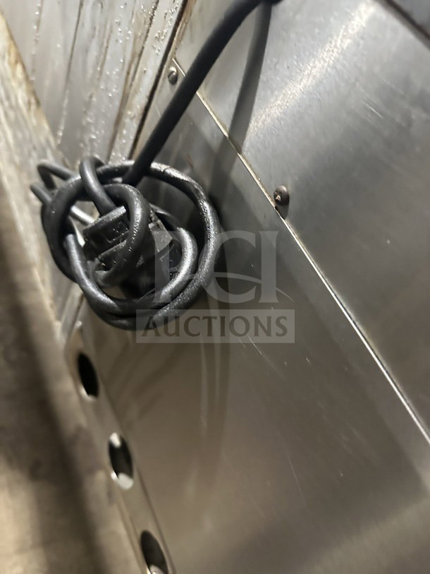 Close-up of Jade Range commercial stainless steel 8-burner range side panel showing coiled power cord. Model: TRLH02ST48.
