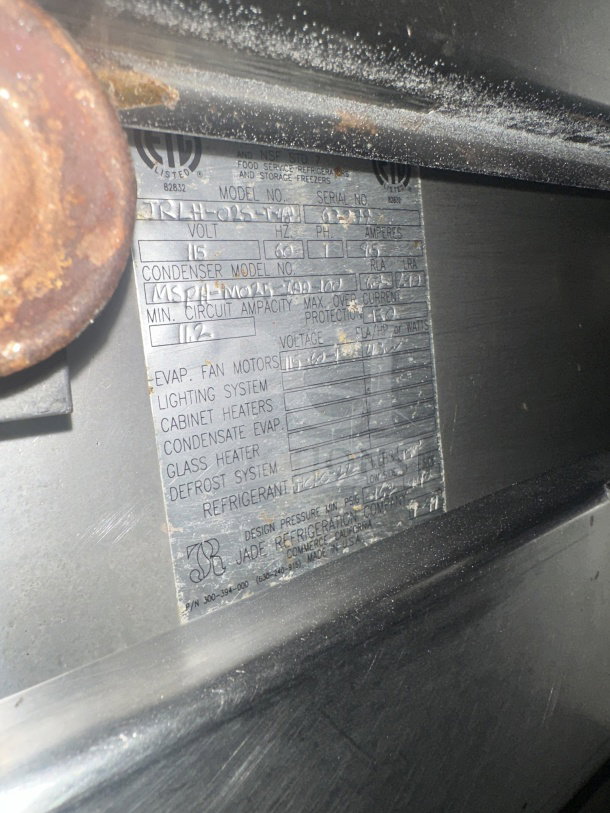 Metallic label on Jade Range model TRLH-02S-T-48 showing specifications, voltage, serial number, and manufacturing details.
