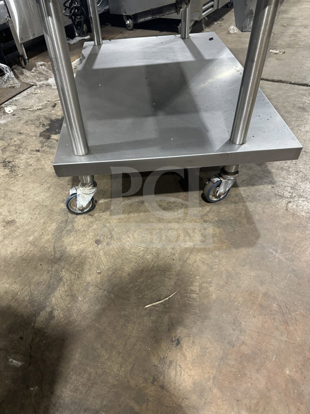 Stainless steel griddle with cheese melter and overfire broiler on casters. Good condition, ideal for commercial use.