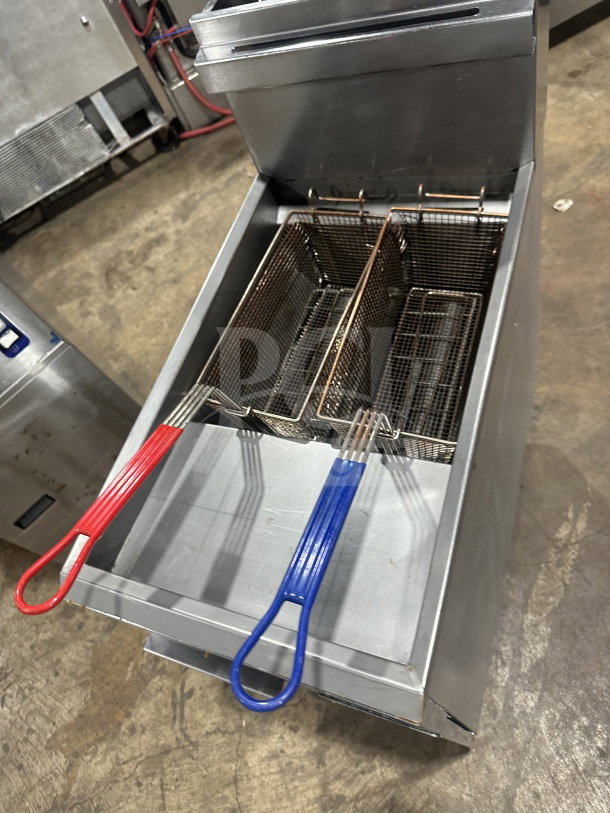 Dukers DCF3NG 40 lb. gas fryer, stainless steel, 3 tube burners, baskets with colored handles, on casters.