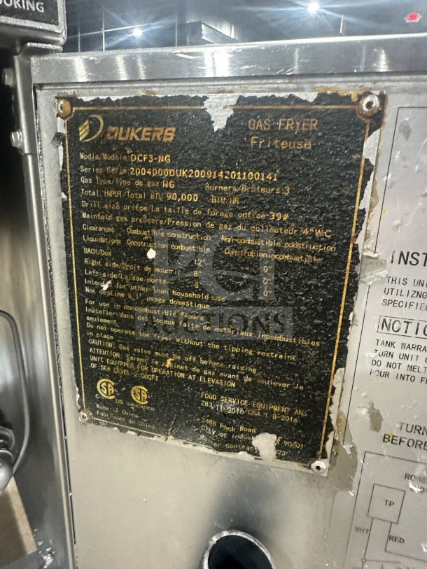 Dukers DCF3NG commercial gas fryer with 40 lb. capacity, 3 tube burners, backsplash, basket hanger. Serial: 2004000. On casters.