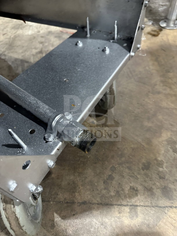 Dukers DCF3NG commercial deep fryer on casters, showing metal frame with visible screws and gas connection.