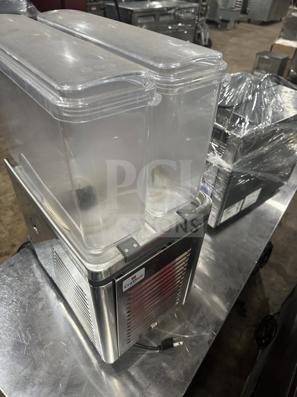 Crathco Classic Bubbler Series beverage dispenser, model CS2E1D16, with clear hoppers and double drip trays, in stainless steel.