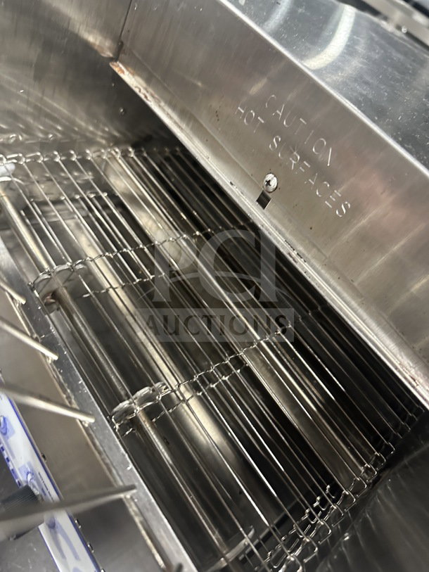 Belleco JT2H commercial conveyor toaster, stainless steel, showing interior and "Caution Hot Surfaces" marking.