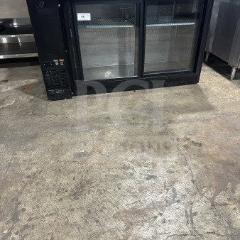 Commercial black back bar refrigerator with poly-coated wire rack, two sliding glass doors, and visible control panel.