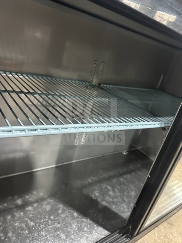 Commercial back bar black refrigerator, poly-coated wire rack, 2 sliding glass doors, interior view, excellent condition.