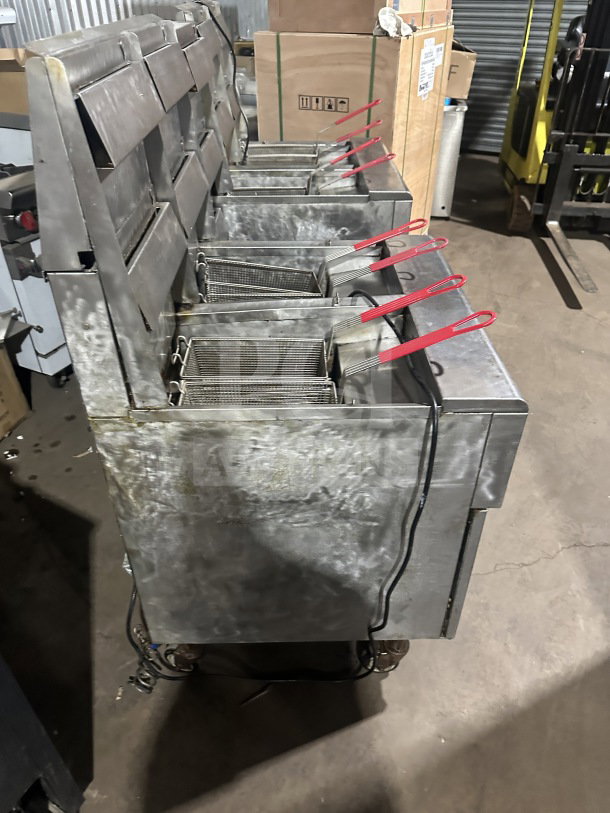 Frymaster FMPH455SC commercial stainless steel 4-bay deep fryer with center dump, backsplash, basket hangers, and digital control.