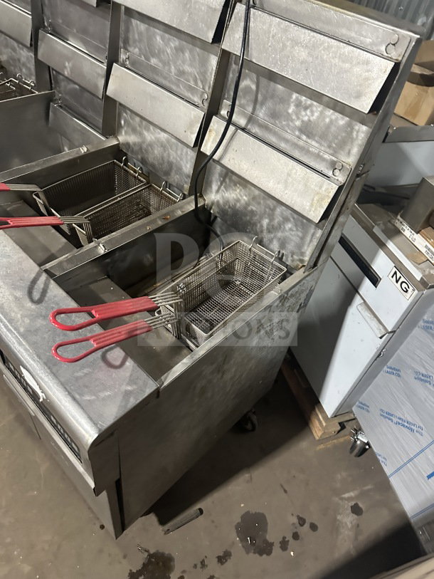 Frymaster FMPH455SC 4-bay stainless steel fryer with center dump station, basket hangers, digital control, oil filter, on casters.