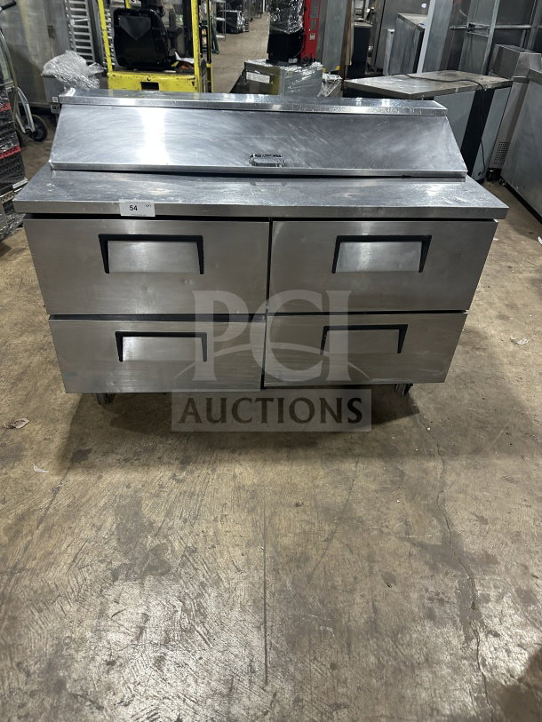 True commercial stainless steel refrigerated sandwich prep table, model TSSU6016D2, with 4 drawers, on casters.