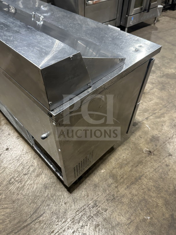 True stainless steel refrigerated sandwich prep table, model TSSU6016D2, with 4 drawers, on casters, in good condition.
