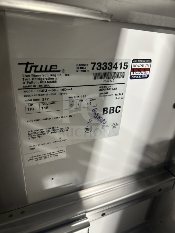 True TSSU6016D2 refrigerated prep table, stainless steel, four drawers, on casters, 115V, model and serial labels visible.