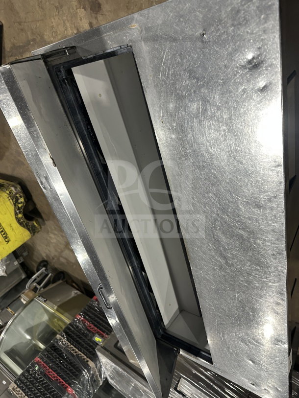 True TSSU6016D2 stainless steel refrigerated prep table, 4 drawers, good condition, on casters, model and serial number visible.
