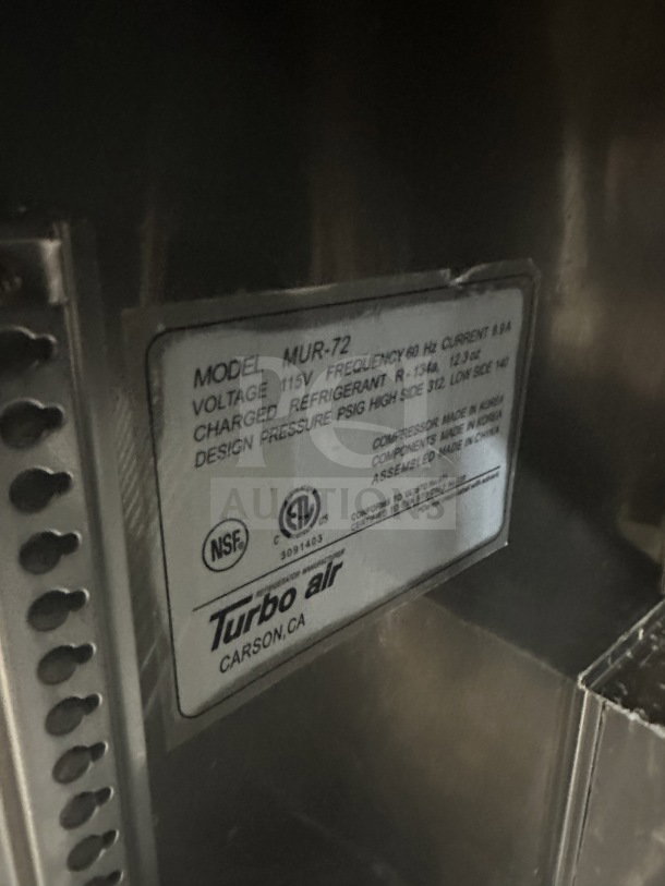 Turbo Air MUR-72 commercial 3-door refrigerator; stainless steel, poly coated racks, 115V, on casters, model tag visible.
