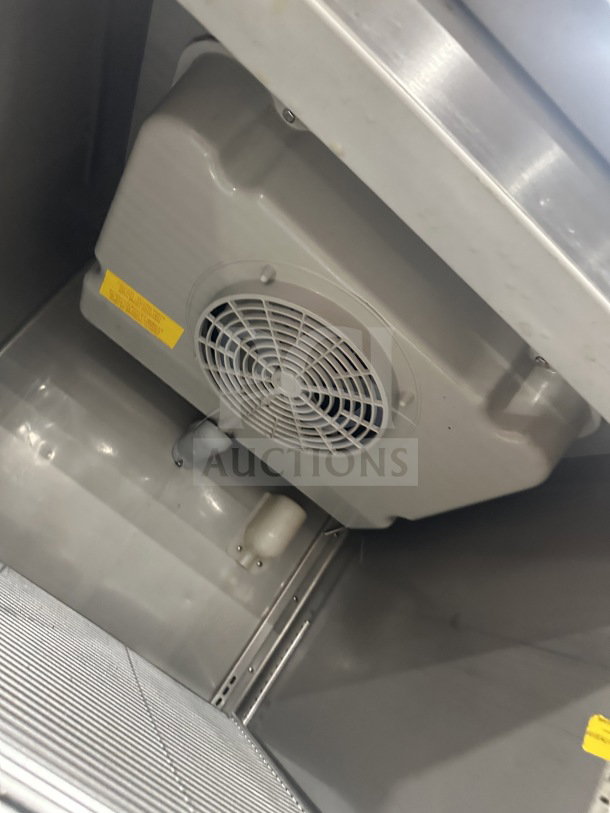 Fagor commercial stainless steel refrigerator interior, showing fan and poly-coated wired rack. In good condition.