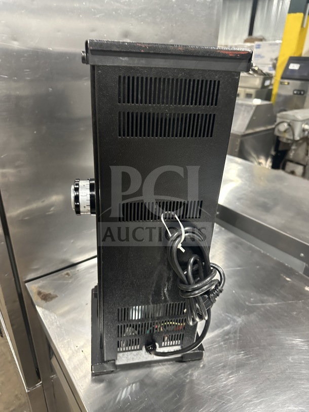 Ditting KR1203 commercial coffee grinder, black, 120V, 1 phase, side view with power cord coiled, good condition.
