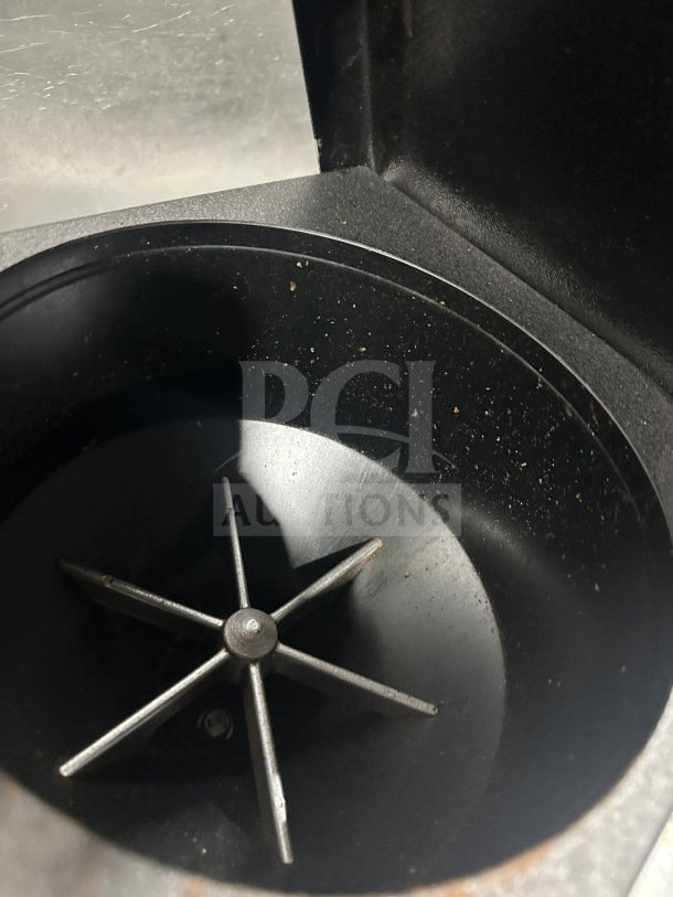 Ditting KR1203 countertop coffee bean grinder interior, black finish, visible grinder blades, model tag info not shown.