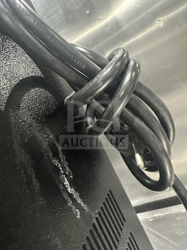 Ditting KR1203 coffee grinder cord, close-up, showing serial number 2022279016. Black textured surface, minor wear.