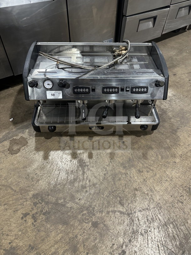 Danesi commercial stainless steel 3-group espresso machine with porta filter handles, in used condition, showcasing control panels.