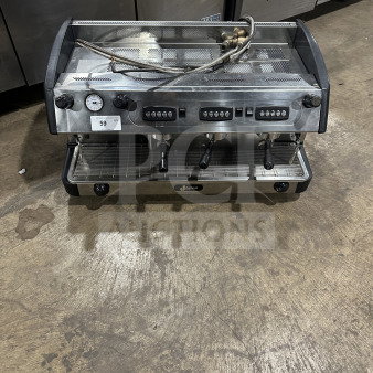 Danesi commercial stainless steel 3-group espresso machine with porta filter handles, in used condition, showcasing control panels.