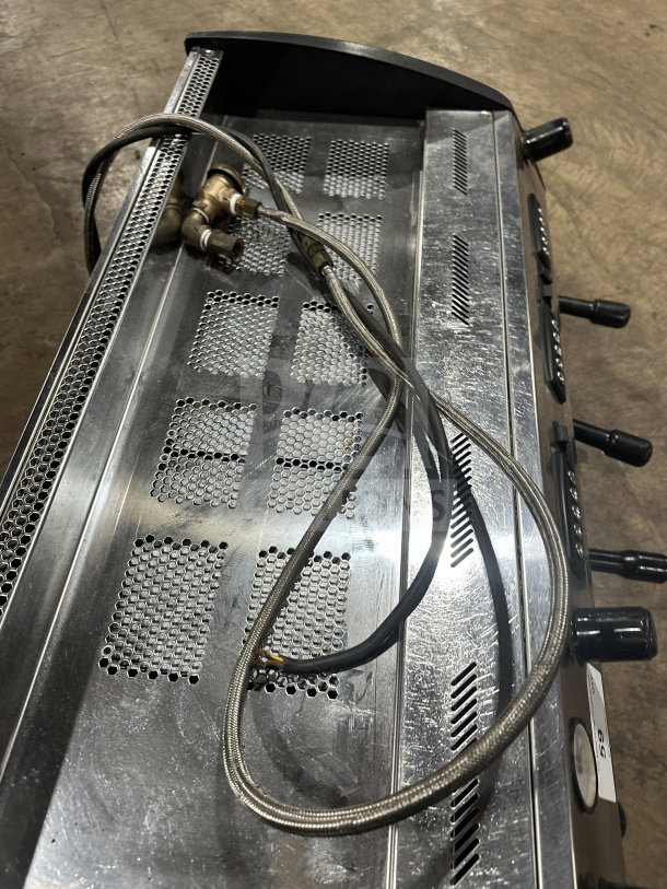 Danesi commercial stainless steel 3-group espresso machine with porta filter handles, shown in used condition.