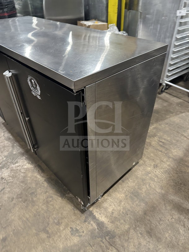 Perlick BBS60RM commercial black 2-door back bar cooler with stainless steel worktop, poly coated wire racks, on casters.