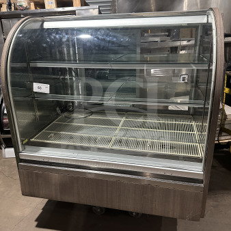 Commercial stainless steel refrigerated bakery display case with curved glass, three tiers, rear sliding glass door, and poly-coated wire rack.
